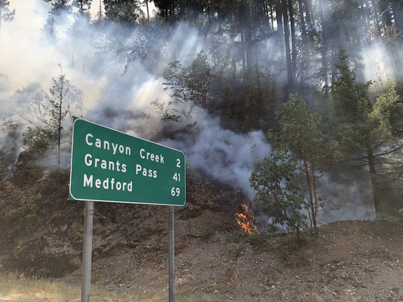 Fire by the Milepost 97 Sign