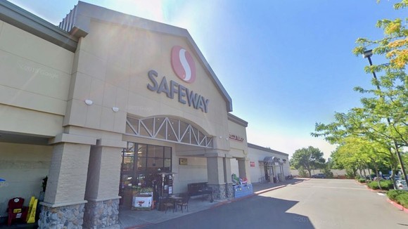 Photo of a large Safeway building with the sun blaring