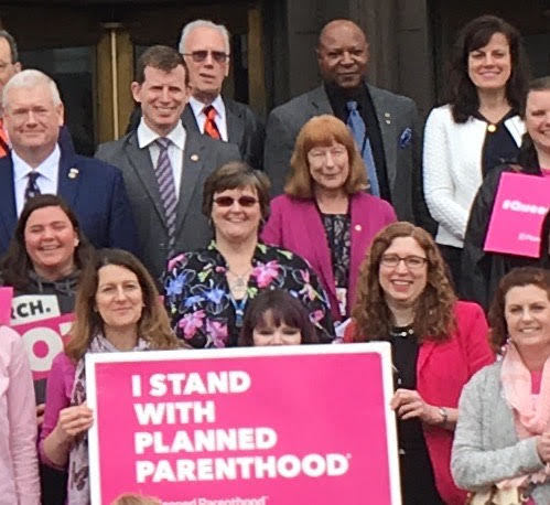 Rep McLain in pink blazer among sea of planned parenthood signs