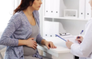 Physician speaking with expecting mother