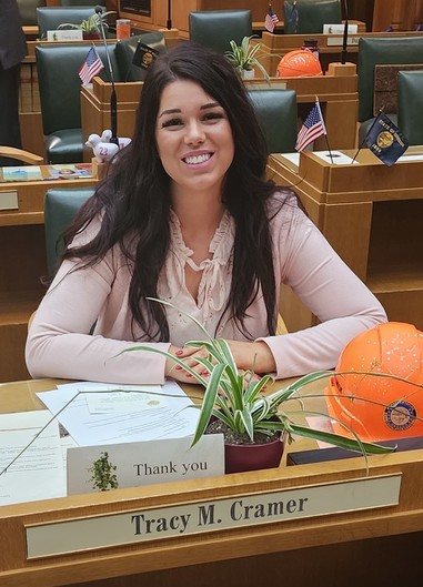 Rep. Cramer sitting at her floor desk