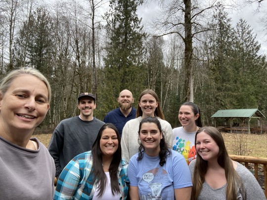 Senator Lieber and her staff with a background of trees