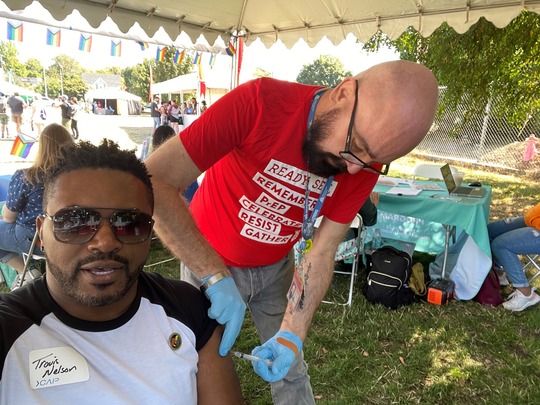 rep nelson receiving an Mpox vaccine at AIDs walk