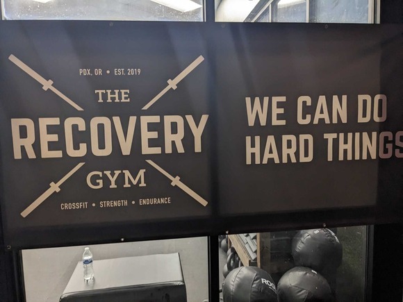 Sign reads "Recovery Gym" and "We Can Do Hard Things"