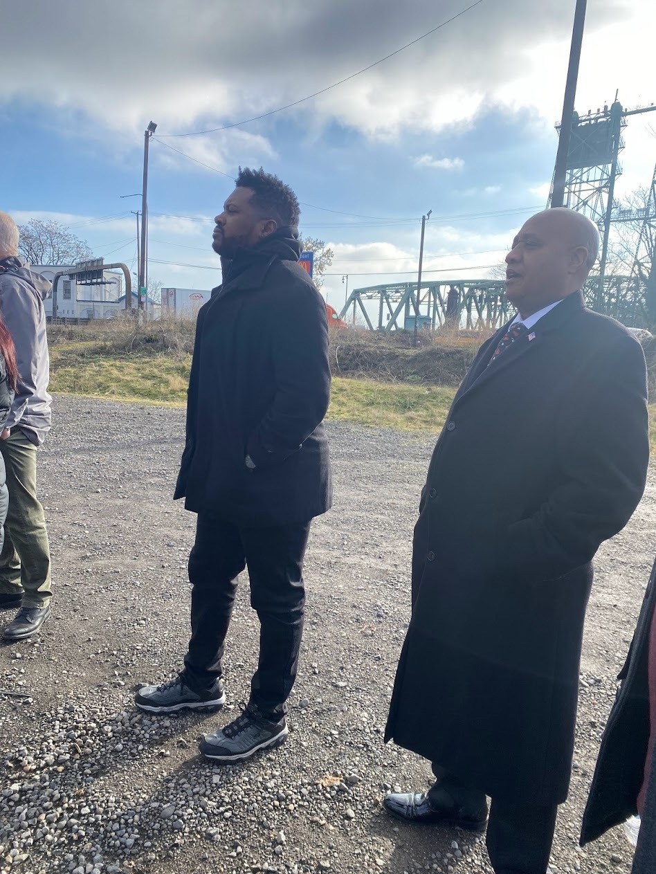 Rep Nelson standing in field with I-5 bridge in the background