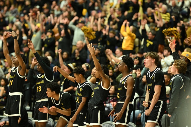 Roosevelt basketball players surrounded by fans in the background