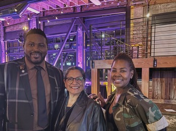 Rep Nelson with Rep Sanchez and  Jones Isadore with buildings behind them