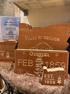 reclaimed wood in state shape and license plates