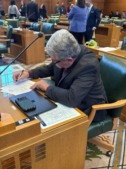 Rep. Lewis working at his floor desk