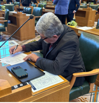 Rep. Lewis working at his floor desk