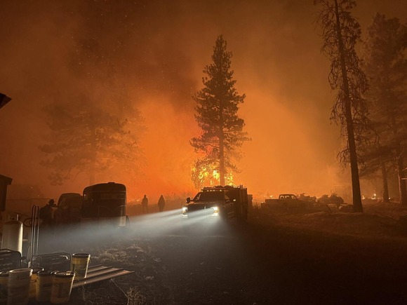Crews provide structural protection for private residences in the path of the Akawa Butte Fire.