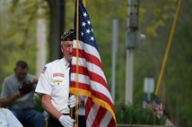 Photo of veteran carrying flag