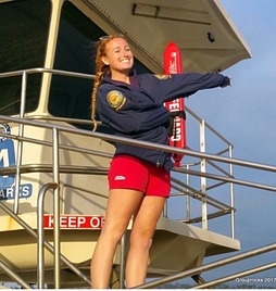 Picture of a person lifeguarding standing on a lifeguard tower