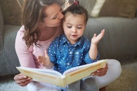 Woman reads a book to a small child
