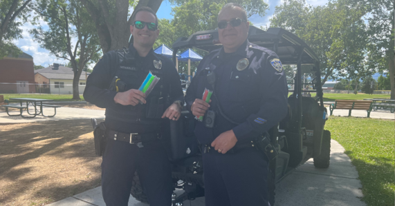 Officer Venables and Officer Maya holding popsicles during Popsicle Patrol event.