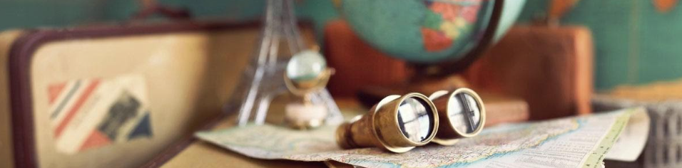 Binoculars with a globe, suitcase, map and Eiffel tower