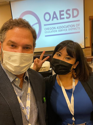 Dan Goldman and Ethelyn Tumalad stand together wearing masks