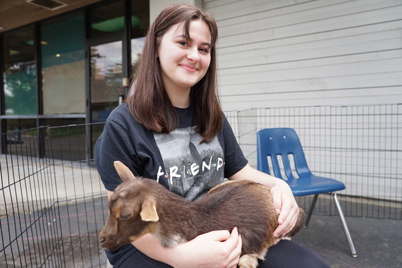 Student holds a baby goat