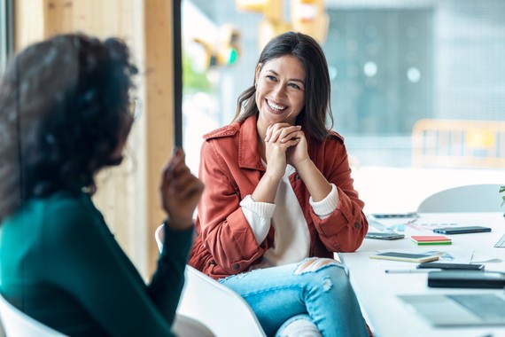 Two women facing each other, talking