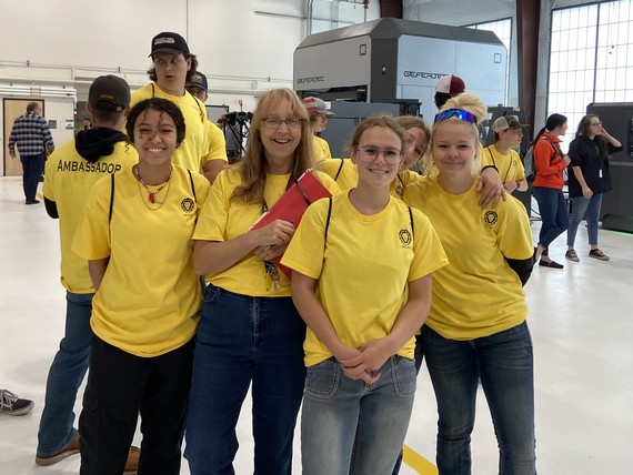 Students stand with their teacher at the Oregon Manufacturing Innovation Center