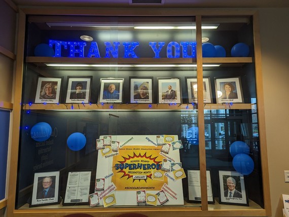 display case includes photos of board members, blue balloons and resolutions the board has passed
