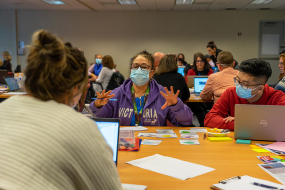 Patricia Jolly talks with Katie Jones and Brandon Zuel in a conference room