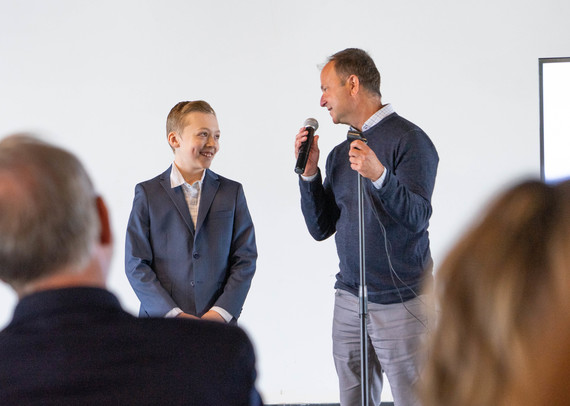 Cole Ziarnik speaks with the president of Junior Achievement