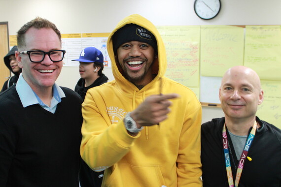 Kendrick Bourne poses for a photo with two teachers