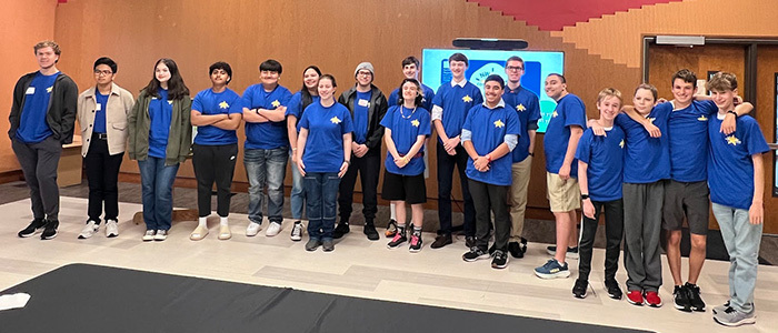 high school students wearing blue t-shirts pose for a photo