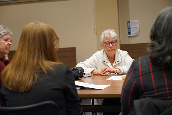 Sen. Suzanne Weber sits at a table and listens to board members and superintendents