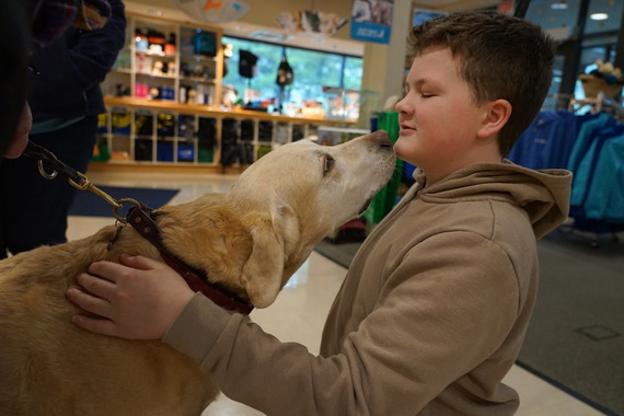 Ryker Register greets a guide dog