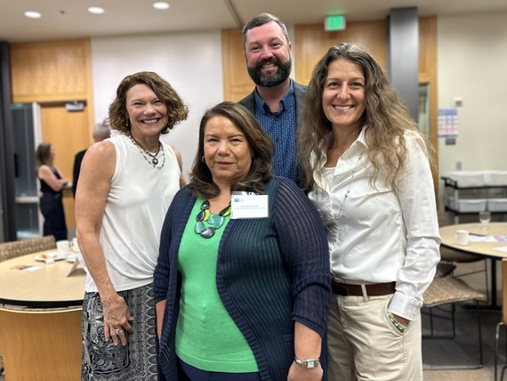 Maureen Wolf, Becky Tymchuk, Adam Whalen and Courtney Neron pose for a photo in a conference room