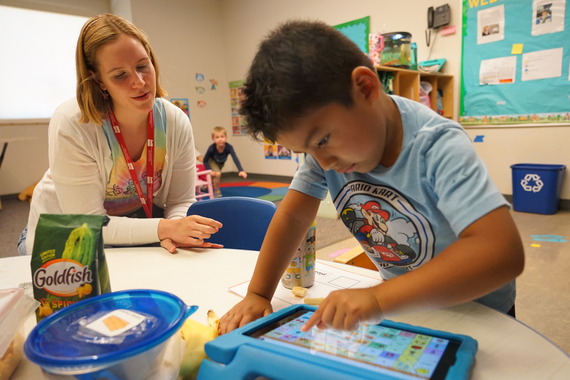 a teacher works with a preschooler
