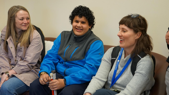 High schooler with two teachers sitting on a couch