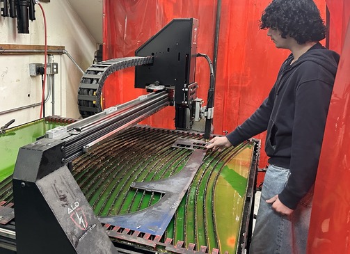 student operating cutting machine