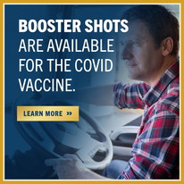 Photo of man driving truck with text overlay stating Booster Shots are Available