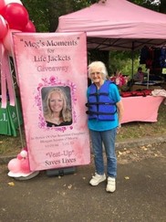 Banner of Meg O’Meara for a life jacket giveaway at Barton Park and one of the happy recipients wearing a life jacket