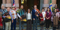 Members of Oregon's tribes pose on stairs in front of Portland City Hall