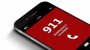 Phone screen with 911 Emergency Number in white letters on red background
