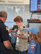 Boy Scout talks into a ham radio