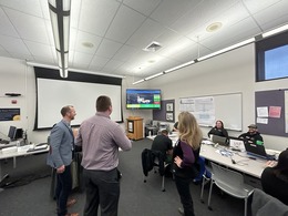 Two men and one woman visit Lane County's Emergency Operations Center