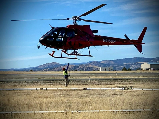 Hooking up the sensor array to the helicopter; photo courtesy of Dominic Leblanc SkyTEM Canada Field Manager 