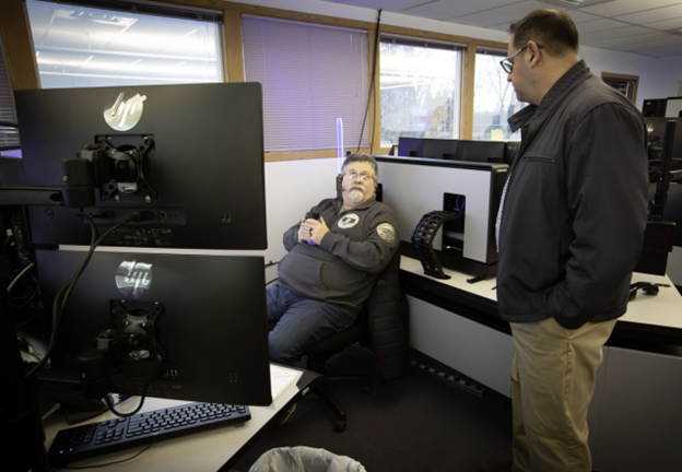 911 Program Manager Frank Kuchta chats with a 911 public safety professional 