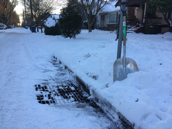 Snow with storm drain shovel