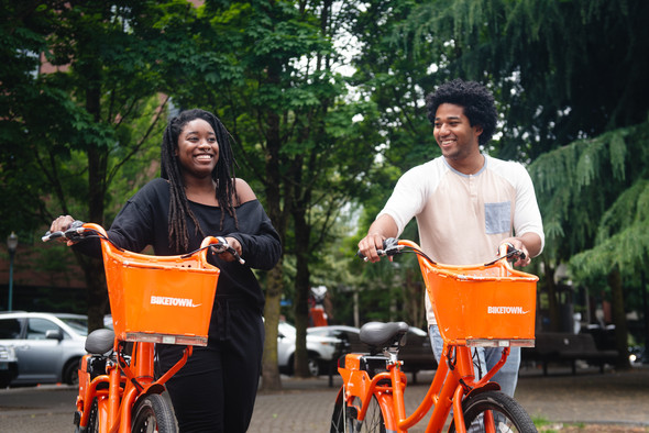 Two people with BIKETOWN bikes