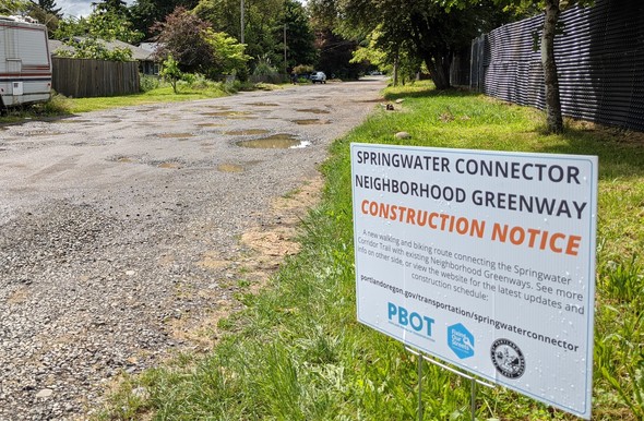 BEFORE: SE 75th street is a graveled, potholed street.
