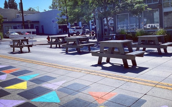 Picnic tables set up on N Denver Avenue as part of the Kenton Main Street Plaza. Photo by the Kenton Business Association.