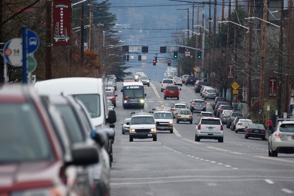 A photo of SE Hawthorne Boulevard with cars and the line 14 bus traveling the street