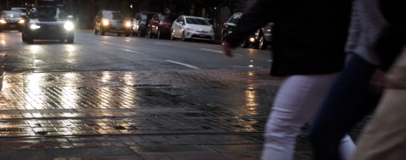Image of people walking across a dark street