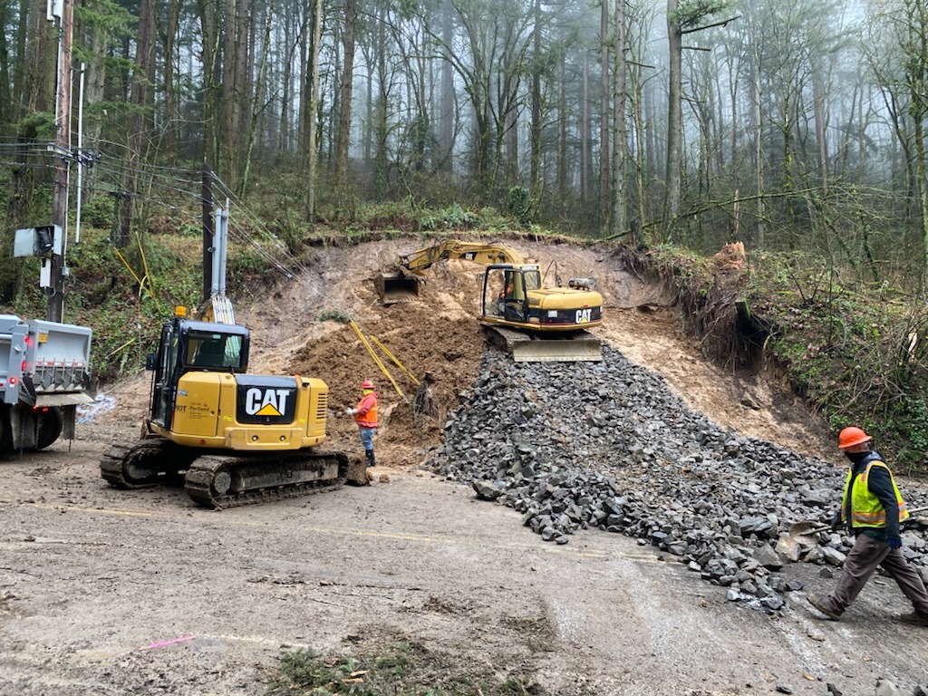 City crews use heavy equipment to clear a landslide Jan 2021